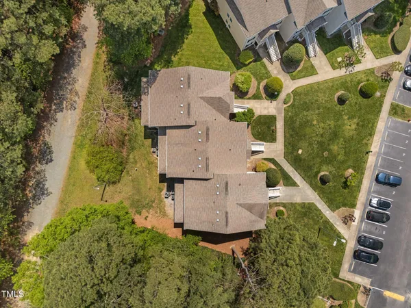 an aerial view of a house with a yard