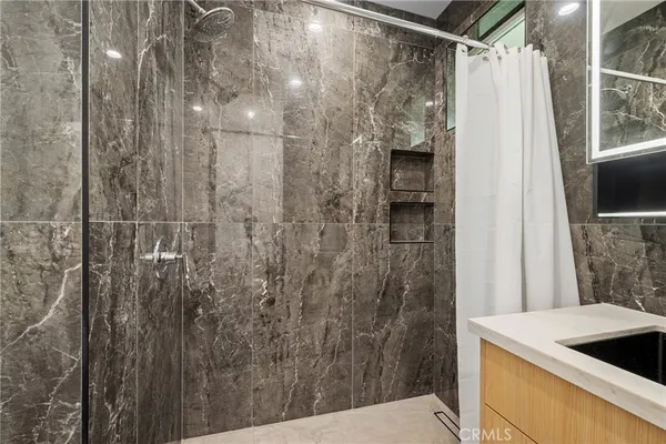 a bathroom with a shower and a sink