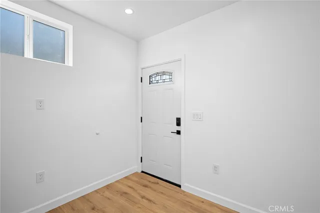 a view of a hallway with wooden floor