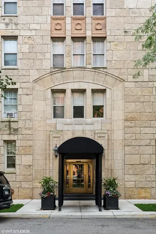 a front view of a building with a garden