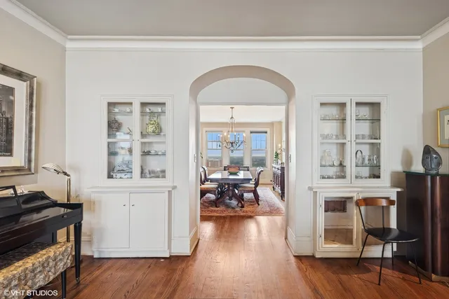 a view of a livingroom with furniture hardwood floor and a large window