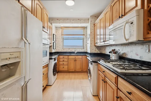 a kitchen with stainless steel appliances granite countertop a stove and a refrigerator