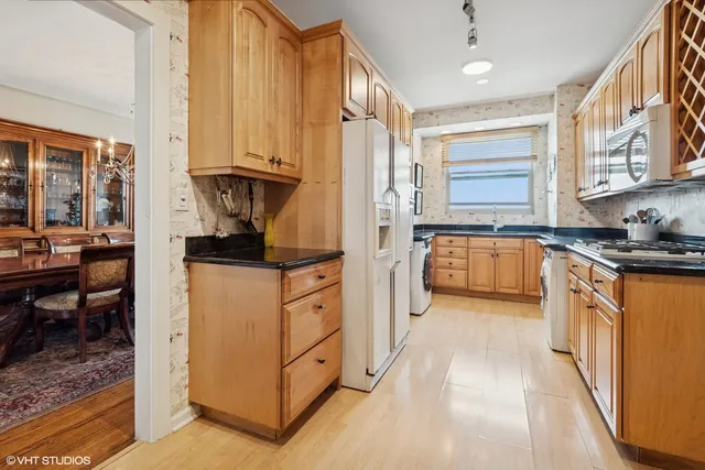 a kitchen with stainless steel appliances granite countertop a stove and a refrigerator