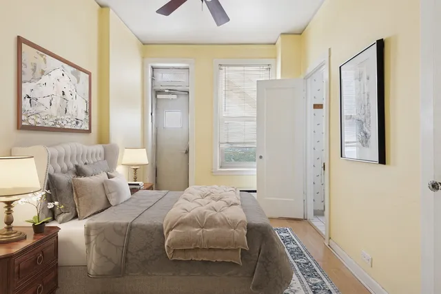 a bedroom with bed and a painting on the wall