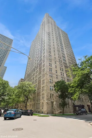 a view of a tall building next to a road