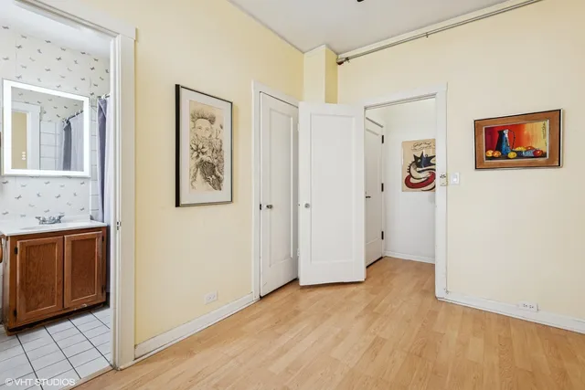 a view of a hallway with closet and bathroom