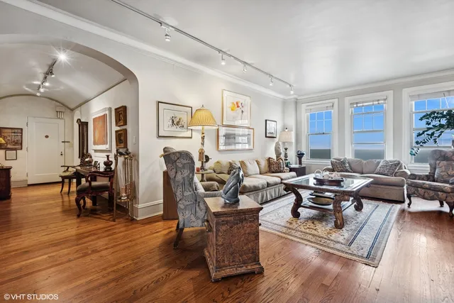a living room with furniture and wooden floor