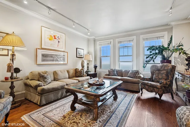 a living room with furniture a rug and a window