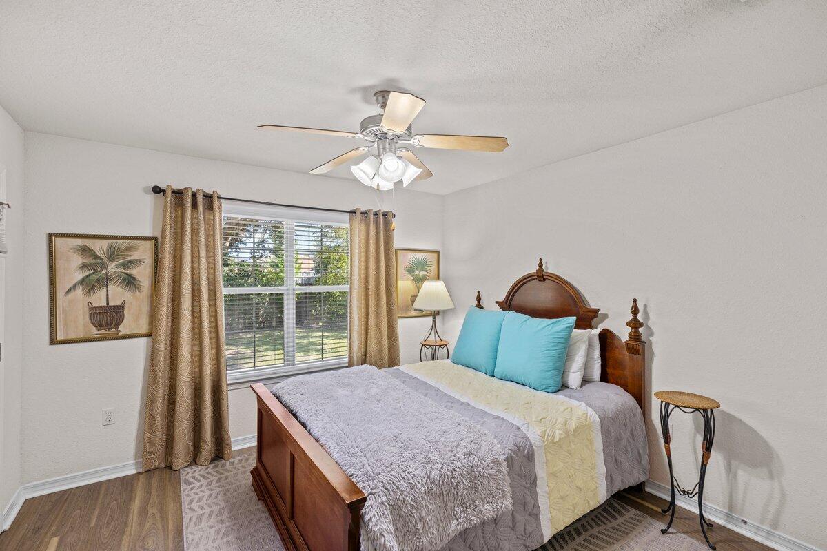 40 Red Bay Court Santa Rosa Beach, FL 32459 - Photo 19 of 49 a bedroom with a large bed and a chandelier