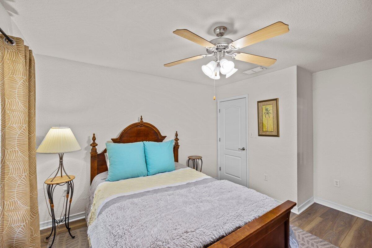 40 Red Bay Court Santa Rosa Beach, FL 32459 - Photo 20 of 49 a bedroom with a bed and a chandelier