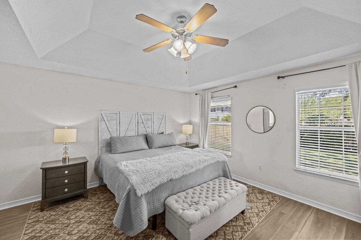 40 Red Bay Court Santa Rosa Beach, FL 32459 - Photo 23 of 49 a bedroom with a bed and a table with wooden floor