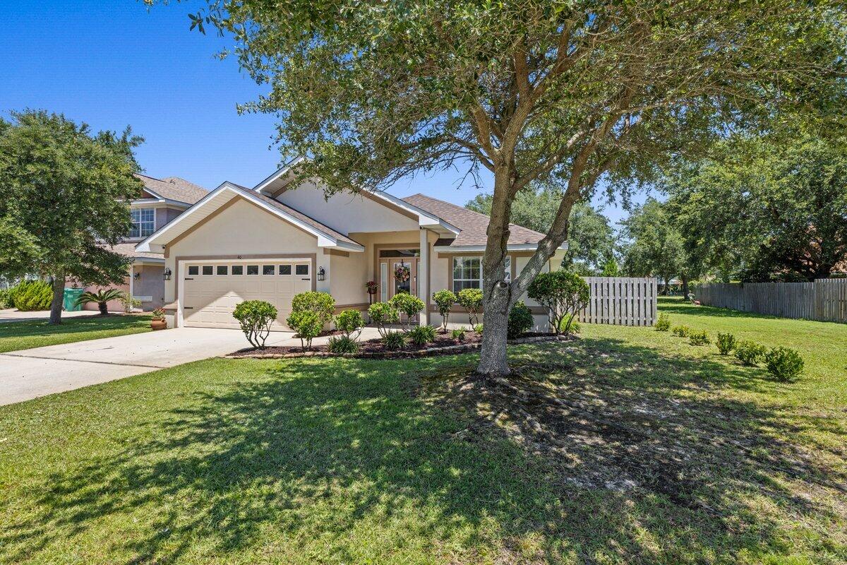 40 Red Bay Court Santa Rosa Beach, FL 32459 - Photo 3 of 49 a front view of a house with garden