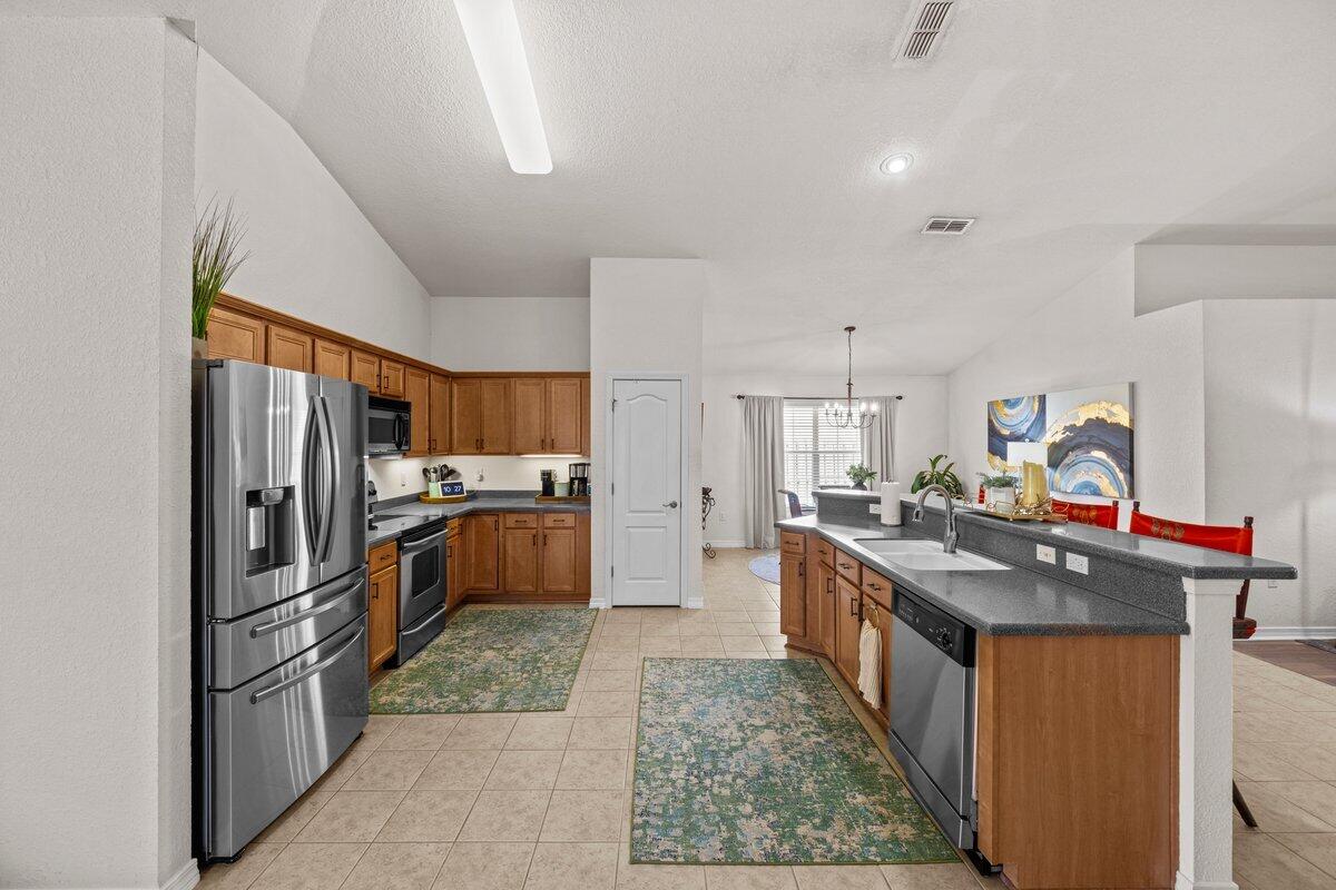 40 Red Bay Court Santa Rosa Beach, FL 32459 - Photo 8 of 49 a kitchen with stainless steel appliances granite countertop a stove refrigerator and sink