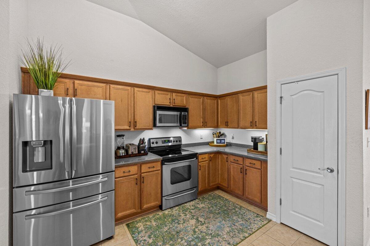 40 Red Bay Court Santa Rosa Beach, FL 32459 - Photo 10 of 49 a kitchen with stainless steel appliances granite countertop a refrigerator a stove a sink a microwave and cabinets