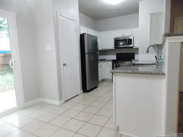 a kitchen with stainless steel appliances a refrigerator sink and microwave