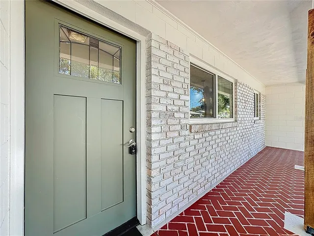 a view of a a dining room with furniture window and wooden floor