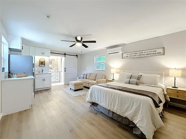 a bed room with couch and a window