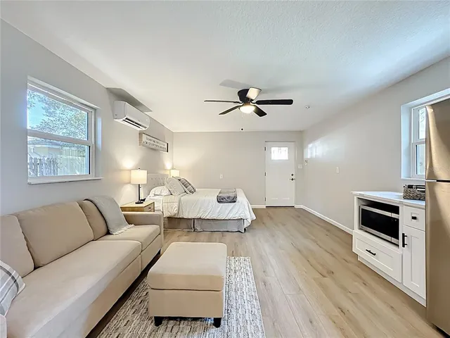 a kitchen with a refrigerator sink and cabinets