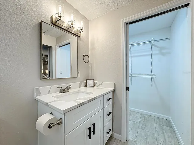 a dining room with furniture and a large window