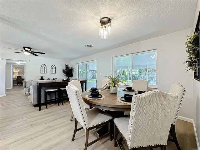 a bedroom with a bed chandelier and a window