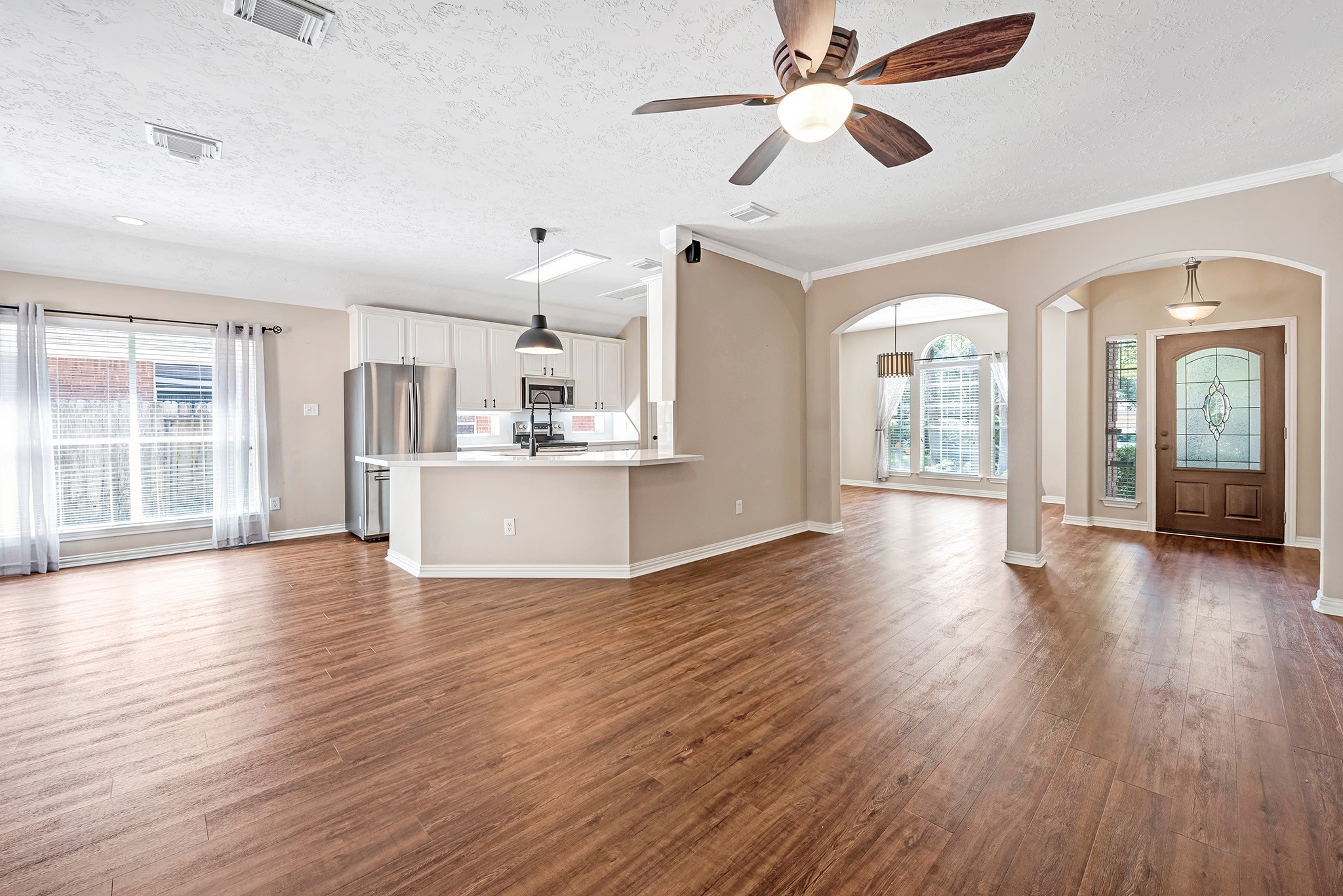 135 West Russet Grove Circle The Woodlands, TX 77384 - Photo 11 of 31 wooden floor in an empty room with a window