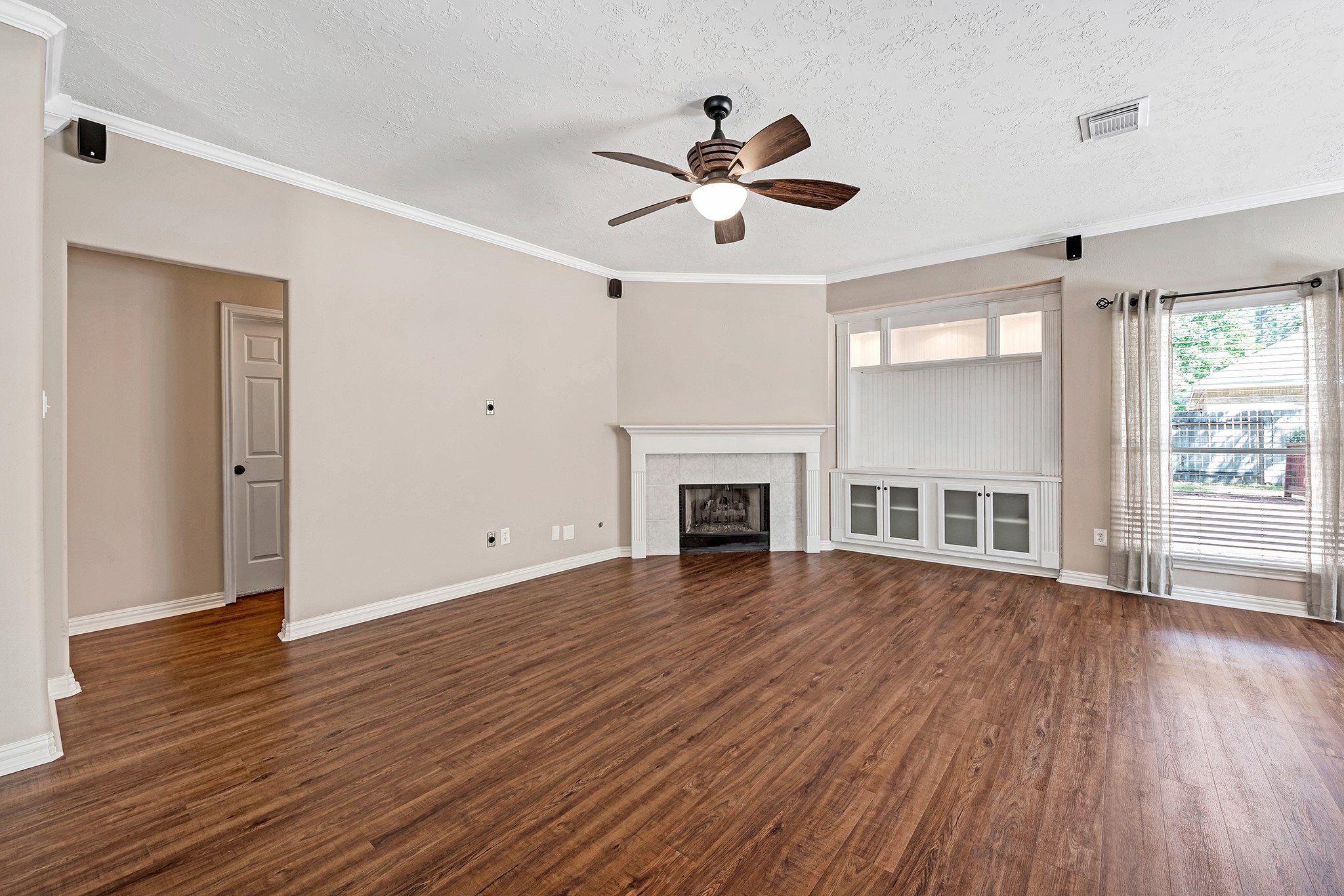 135 West Russet Grove Circle The Woodlands, TX 77384 - Photo 13 of 31 a view of an empty room with wooden floor and a window