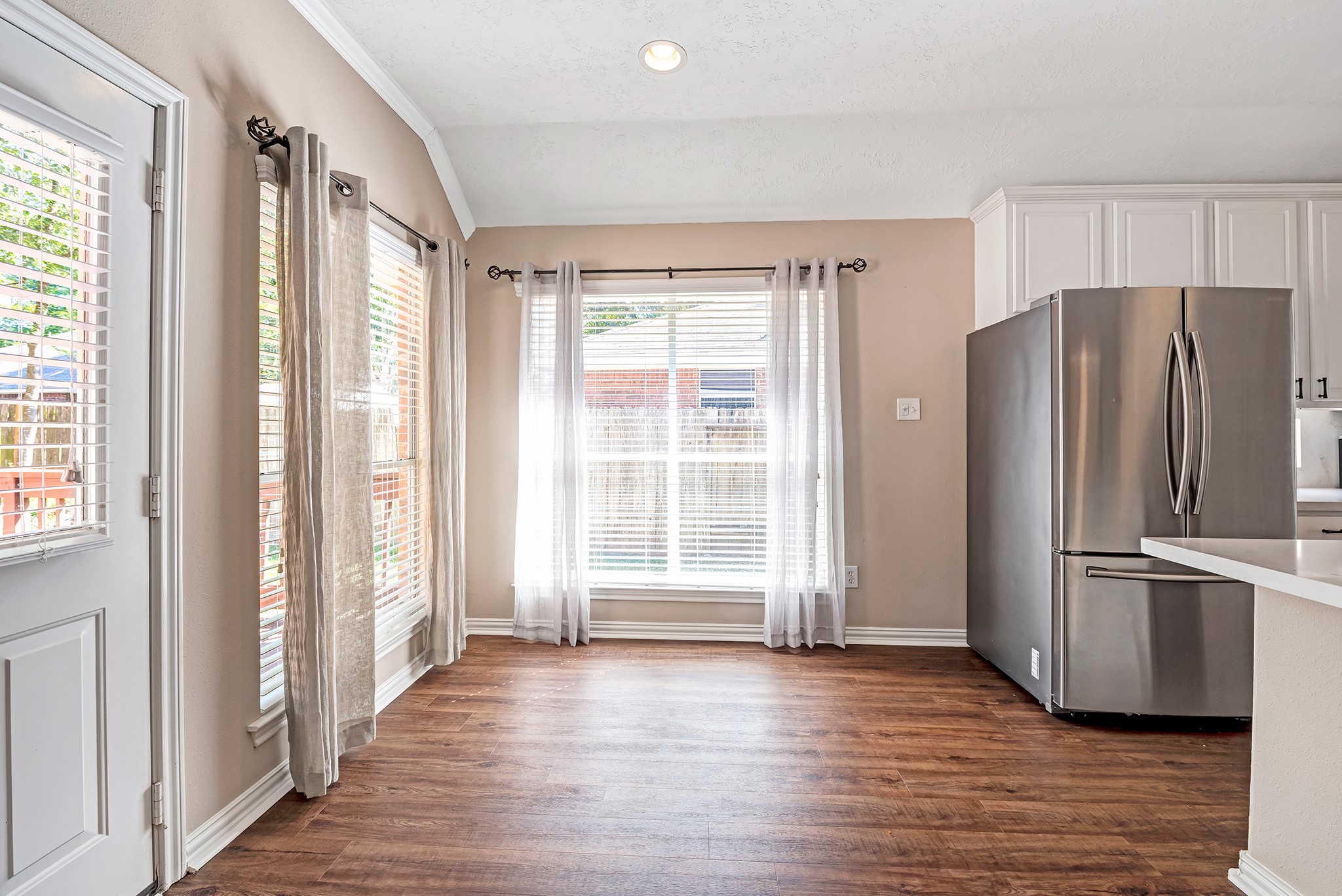 135 West Russet Grove Circle The Woodlands, TX 77384 - Photo 15 of 31 a view of a kitchen with wooden floor and refrigerator