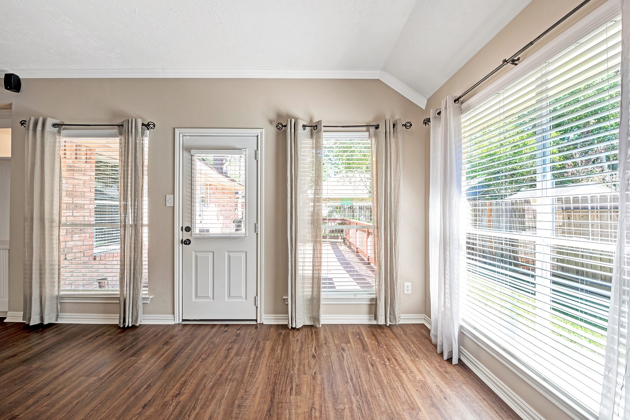 135 West Russet Grove Circle The Woodlands, TX 77384 - Photo 16 of 31 a view of an empty room with wooden floor and a window