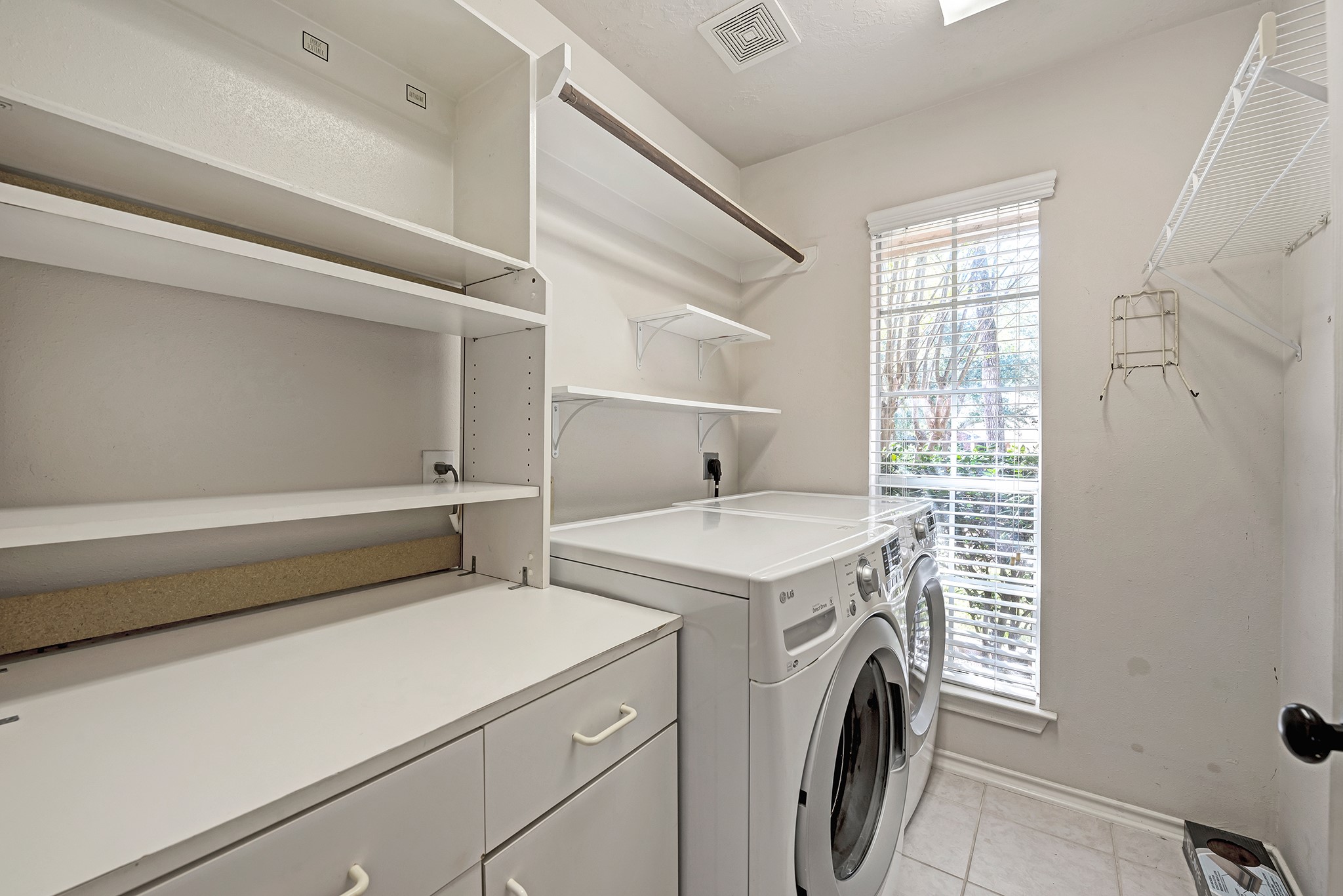 135 West Russet Grove Circle The Woodlands, TX 77384 - Photo 21 of 31 a utility room with dryer and washer