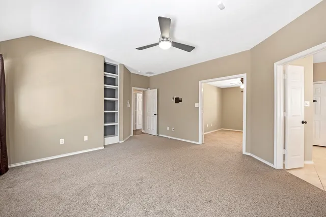 an empty room with closet and windows