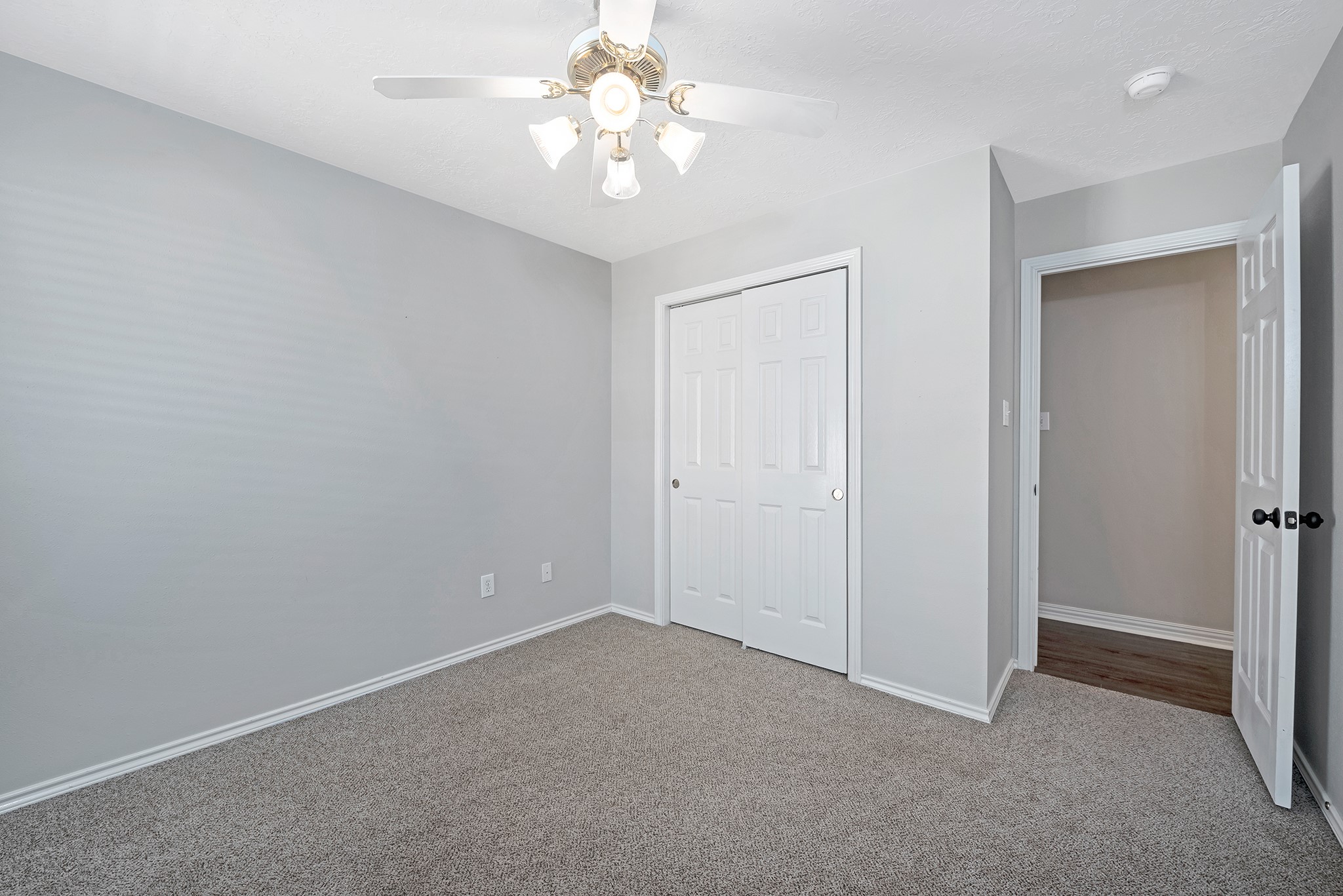 135 West Russet Grove Circle The Woodlands, TX 77384 - Photo 29 of 31 an empty room with a chandelier fan and closet