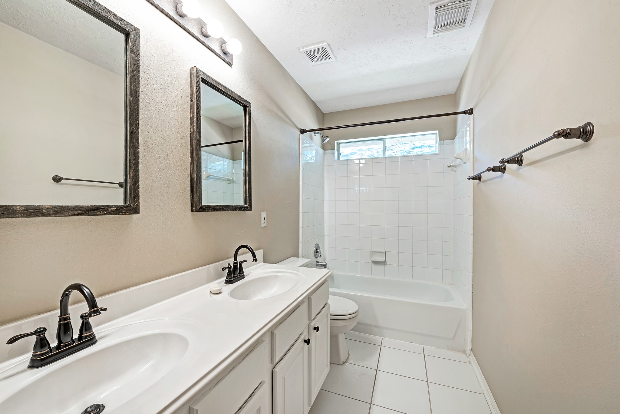 135 West Russet Grove Circle The Woodlands, TX 77384 - Photo 30 of 31 a bathroom with a double vanity sink toilet a shower and a mirror