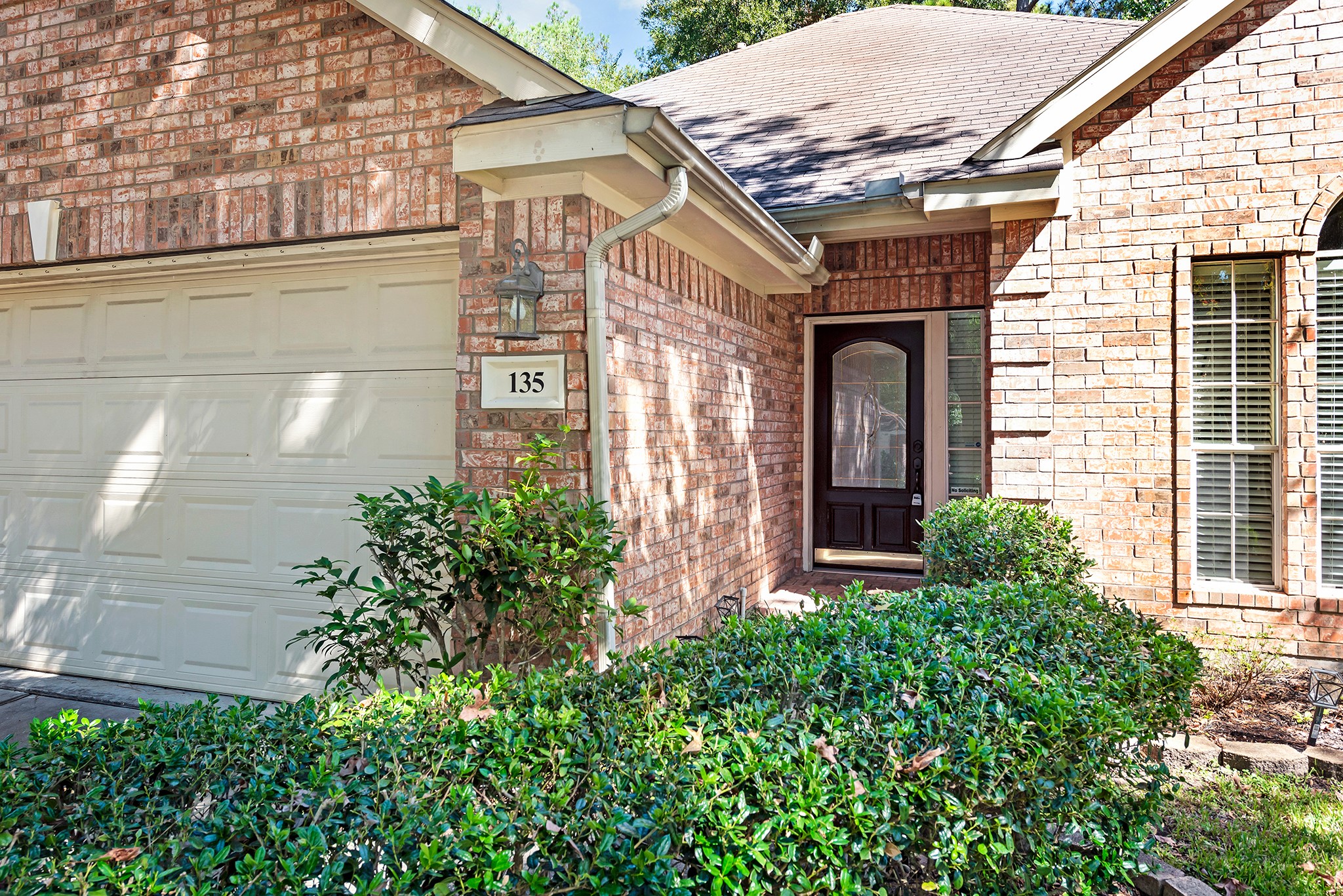 135 West Russet Grove Circle The Woodlands, TX 77384 - Photo 3 of 31 a front view of a house with plants