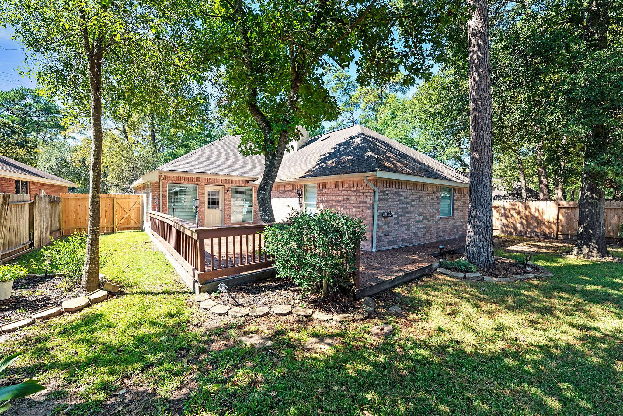 135 West Russet Grove Circle The Woodlands, TX 77384 - Photo 4 of 31 a front view of a house with garden