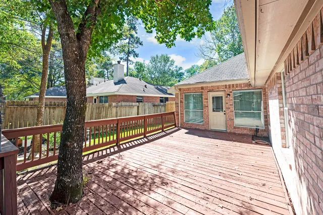 a view of a house with backyard and deck