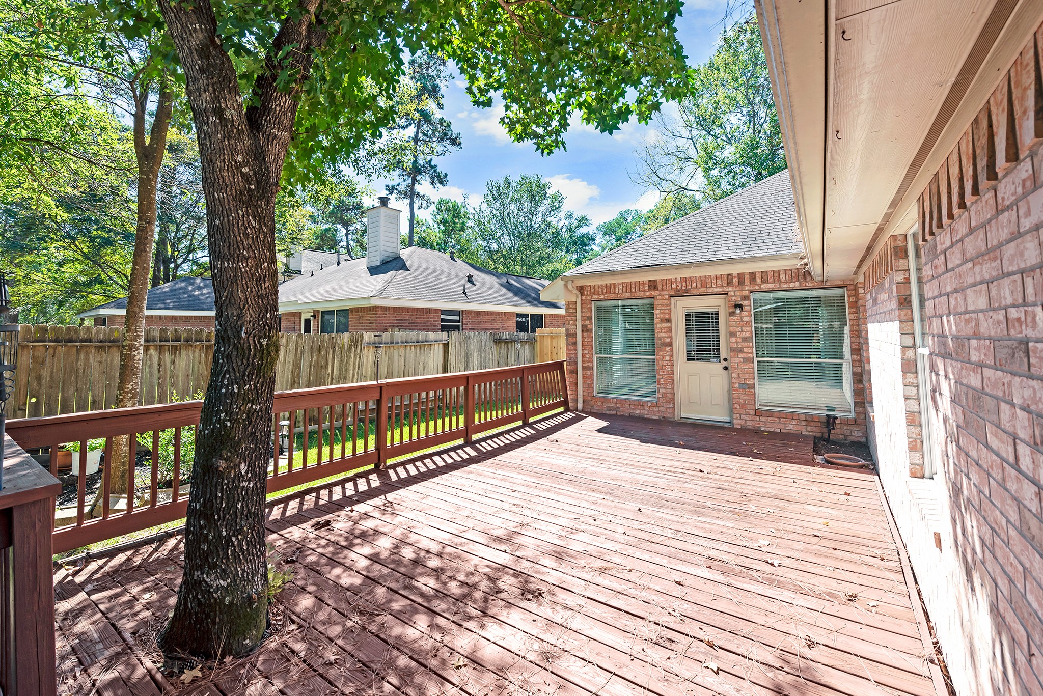 135 West Russet Grove Circle The Woodlands, TX 77384 - Photo 5 of 31 a view of a house with backyard and deck