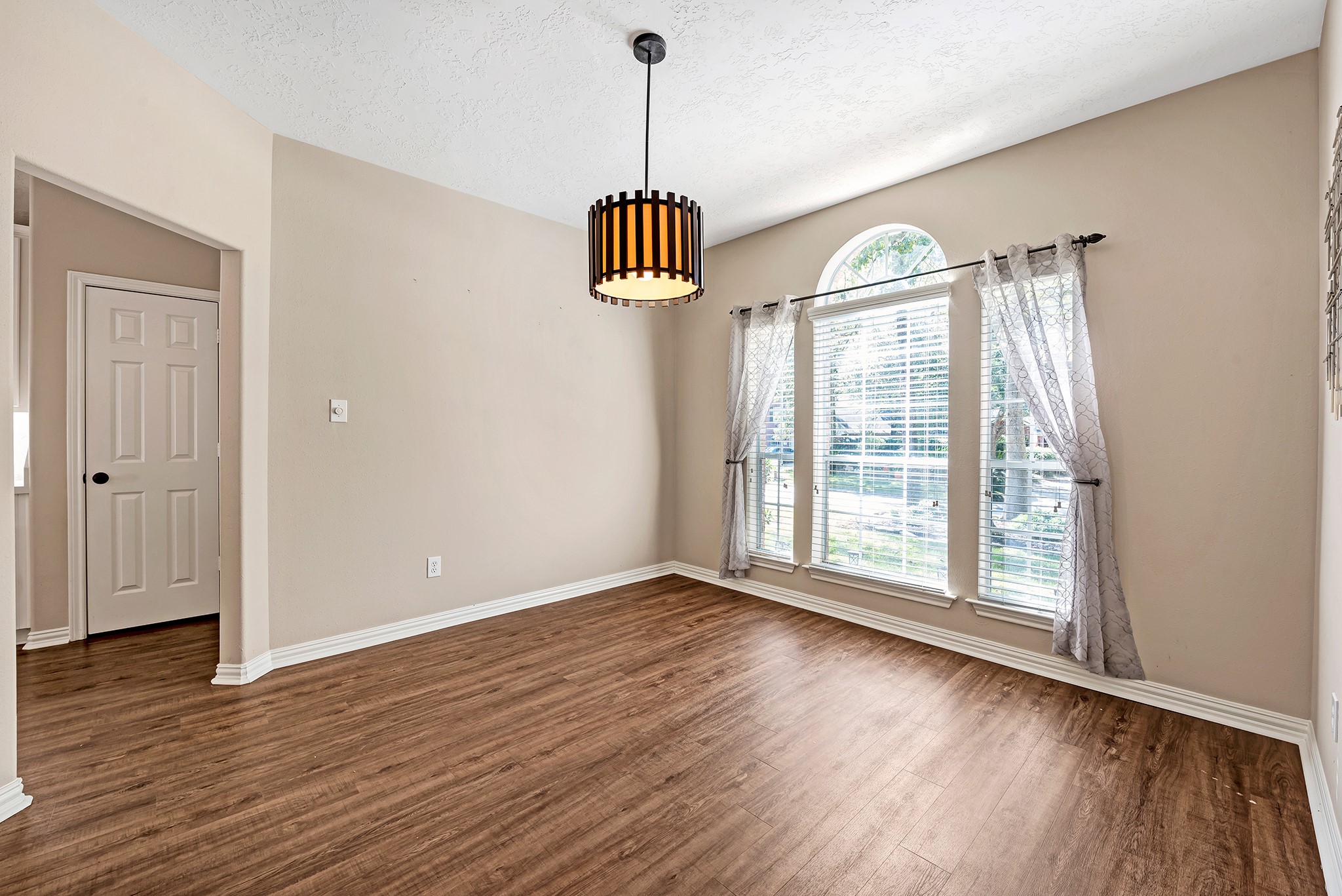 135 West Russet Grove Circle The Woodlands, TX 77384 - Photo 8 of 31 a view of an empty room with wooden floor and a window