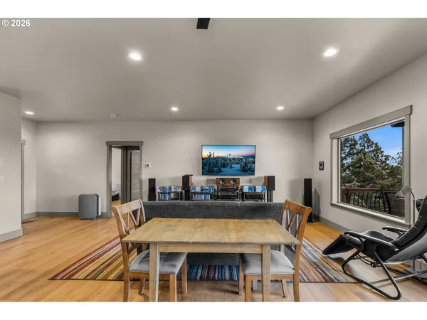 a living room with furniture a flat screen tv and a table