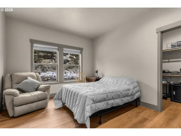 a bedroom with a bed couch and window