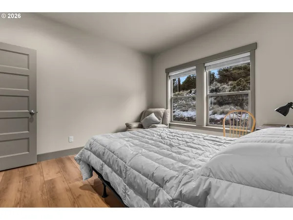 a bedroom with a bed and a large window