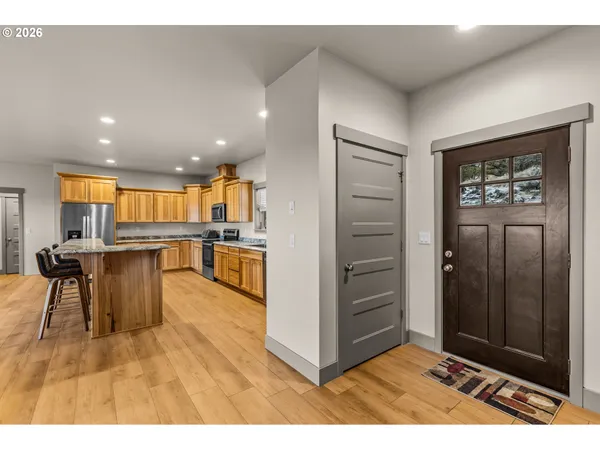 a open kitchen with white cabinets and stainless steel appliances