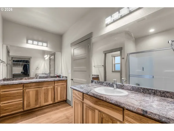 a bathroom with a granite countertop sink a mirror and a vanity