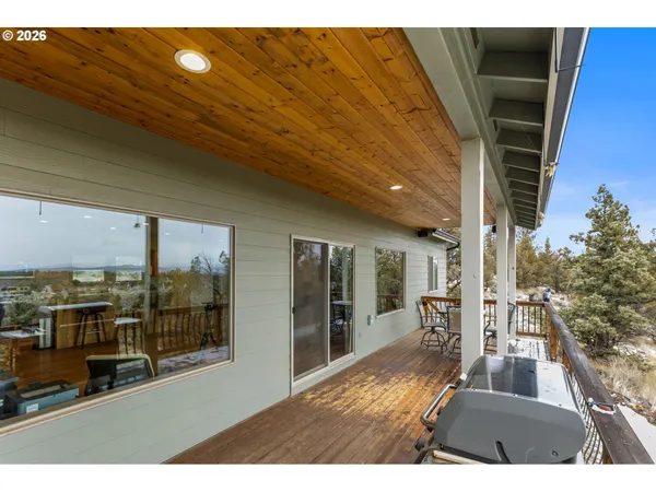 a view of a balcony with wooden floor and outdoor seating