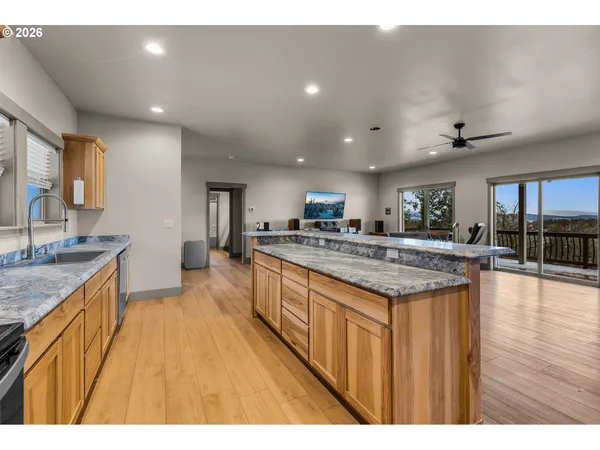 a large kitchen with granite countertop a large counter top and sink