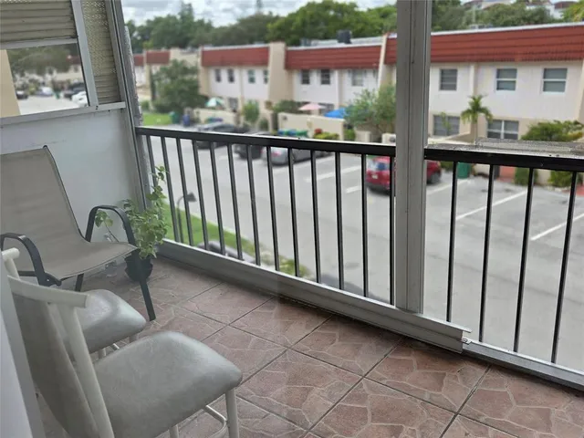 a balcony view with a seating space