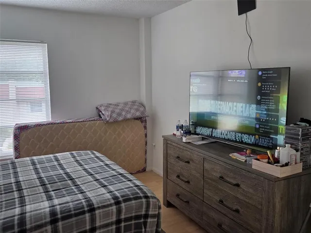 a bedroom with a bed and a night stand