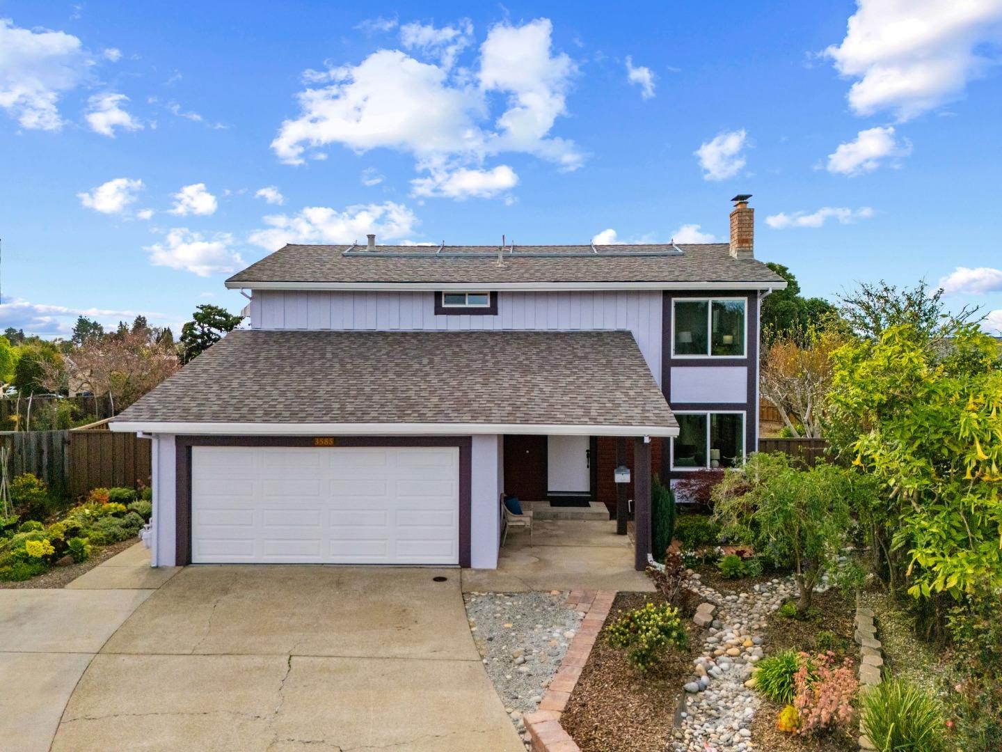 3585 Surry Place Fremont, CA 94536 - Photo 37 of 47 a front view of a house with a yard and garage