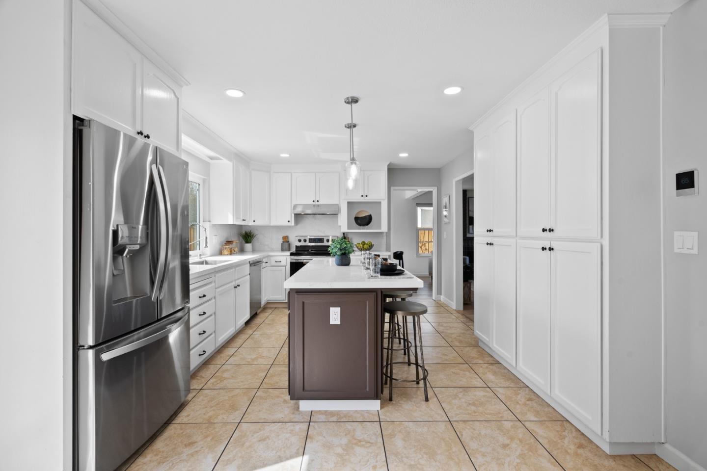 3585 Surry Place Fremont, CA 94536 - Photo 9 of 47 a kitchen with stainless steel appliances a refrigerator sink and cabinets
