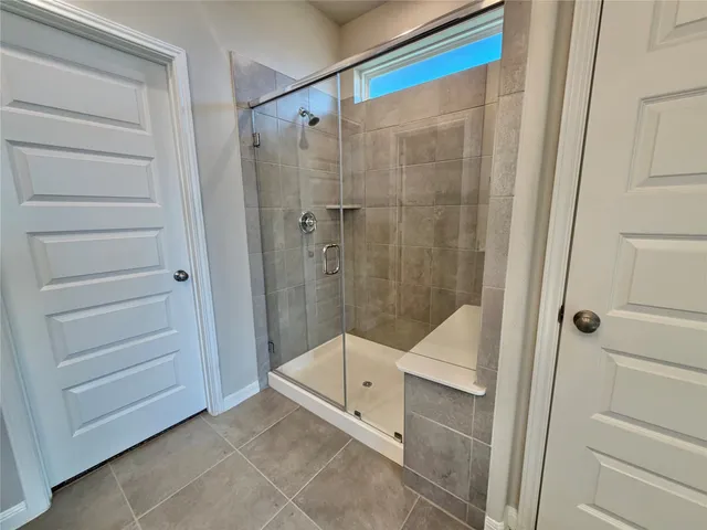 a bathroom with a shower and toilet