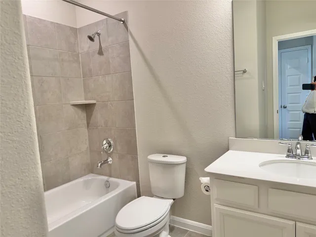 a bathroom with a sink a toilet and bathtub